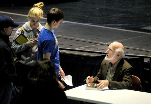 Dr. Jim Loewen speaking with students after an event